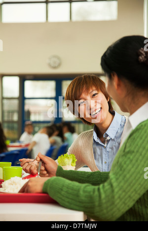 Les enseignants de parler au déjeuner dans la cafétéria de l'école Banque D'Images
