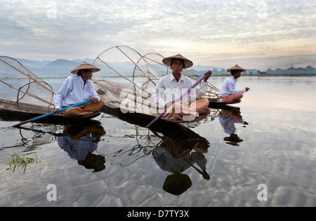 Les pêcheurs d'aviron jambe ethnie Intha au coucher du soleil sur le lac Inle, lac Inle, l'État Shan, en Birmanie Banque D'Images