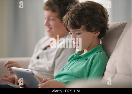 Young boy sitting on sofa Banque D'Images