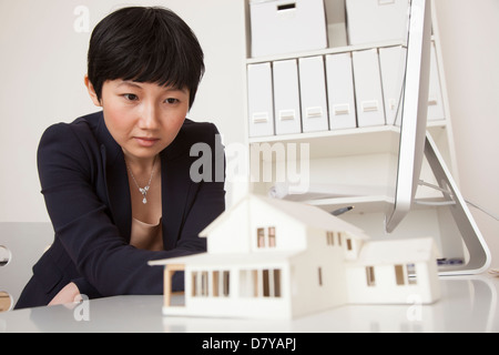 Businesswoman working on model in office Banque D'Images