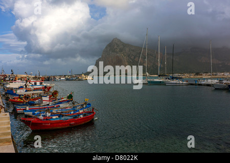 Bateaux de pêche rouge et montagne couverte de nuages Banque D'Images