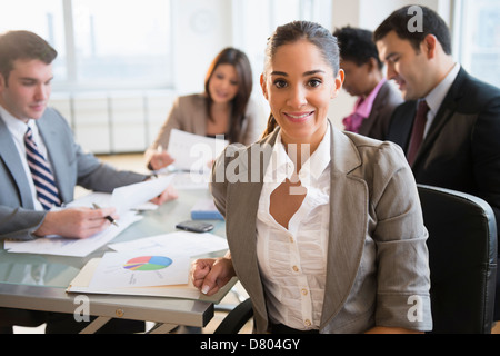 Businesswoman smiling in meeting Banque D'Images