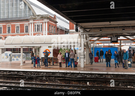 Les passagers qui attendent à Kensington Olympia overground railway station Banque D'Images