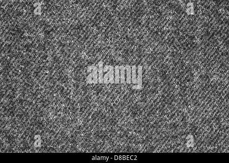 Cette image met en valeur la texture du tissu denim gris, mettant en valeur la structure tissée et les variations de couleurs subtiles. Le denim est un matériau durable et polyvalent couramment utilisé pour les vêtements, tels que les jeans et les vestes. La couleur grise ajoute un ton moderne et neutre au tissu, ce qui le rend adapté à divers styles et designs de mode. Banque D'Images