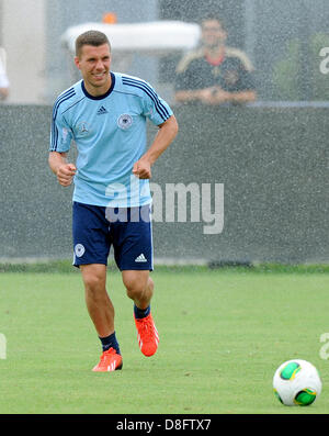 Miami, Floride, USA. 28 mai 2013. L'équipe nationale de football allemand Lukas Podolski traverse une eau de type sprinkleur pendant une session de formation à Barry University à Miami, Floride, USA, 28 mai 2013. L'équipe allemande est en tournée aux Etats-Unis avant le 03 juin. Photo : THOMAS EISENHUTH/dpa/Alamy Live News Banque D'Images