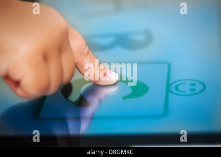 Les tout-petits un doigt sur un écran tactile Tablet l'apprentissage de l'alphabet à l'aide de logiciels éducatifs. Banque D'Images