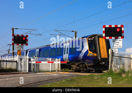 Des panneaux d'avertissement. feux de circulation et d'urgence téléphone à côté d'un passage à niveau, près d'Irvine, Ayrshire, Scotland Banque D'Images