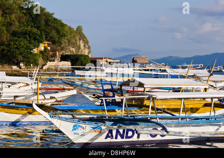 De nombreux bateaux Philippine bancas (outrigger) dans un paysage marin tropical - Puerto Galera Philippines Banque D'Images