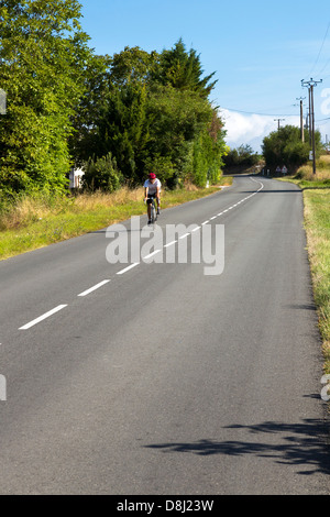 Les cyclistes sur route de campagne, Charentes Maritime, France Banque D'Images