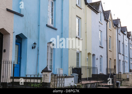 Terrasse de vieux chalets avec façades peintes et fait fenêtres et portes cintrées, Dartmouth, Devon. Banque D'Images