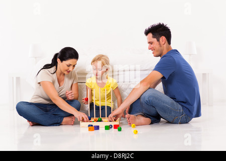 Happy Family playing toy jeu avec fille sur plancher de chambre à coucher Banque D'Images