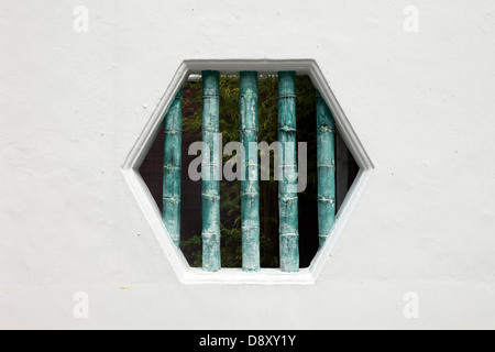 C'est une photo d'une fenêtre ou une porte en forme de miel avec des bars en bambou Banque D'Images