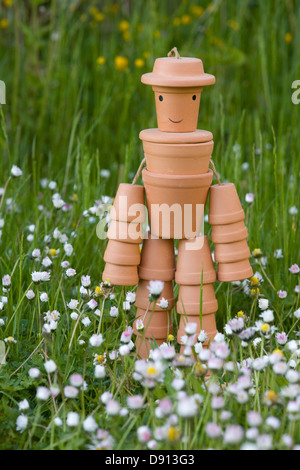 L'homme a fait à partir de pots de fleurs se trouvait dans une prairie daisy Bellis perennis Banque D'Images