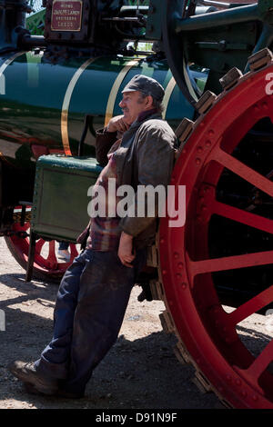 Hampshire, England, UK. 8 juin 2013. Le conducteur d'un moteur de traction à vapeur a un moment de repos au cours de la guerre sur la ligne, une célébration de l'avant à la maison de la Seconde Guerre mondiale sur le milieu Hants Railway Line Cresson dans le Hampshire. Re-enactment societies tenue que les civils ou militaires dans les ornements que la musique, la mode, les uniformes et les véhicules de l'époque sont tous sur l'affichage, avec un certain nombre de trains à vapeur pour le transport de personnes différentes stations le long de la ligne qui ont participé à l'événement. Credit : Patricia Phillips/Alamy Live News Banque D'Images