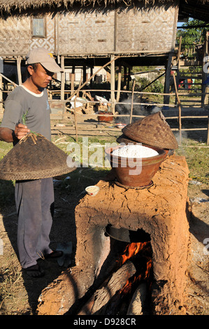 La cuisson du riz gluant villageois dans l'occasion de la cérémonie de la pleine lune de décembre, Nyaungshwe, lac Inle, l'État de Shan, Myanmar Banque D'Images