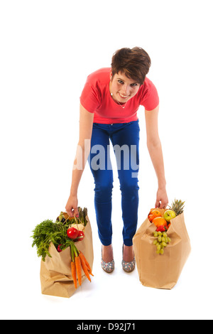 Jolie jeune femme avec de gros sacs de légumes sains et fruits isolés sur fond blanc Banque D'Images