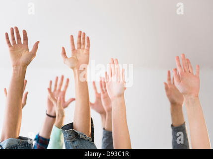 People's hands raised in air Banque D'Images