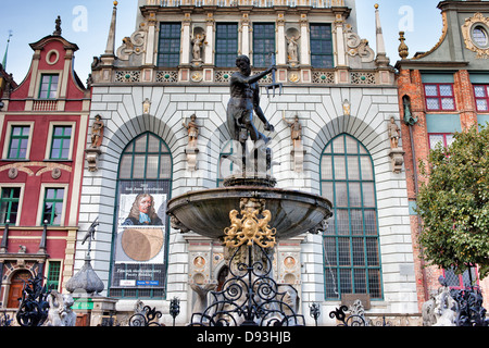 Fontaine de Neptune avec statue de bronze du dieu romain de la mer et de la Cour d'Artus en arrière-plan, la vieille ville de Gdansk, Pologne. Banque D'Images