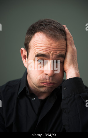 Head and shoulders Portrait of mature Man with Hand on Head Banque D'Images