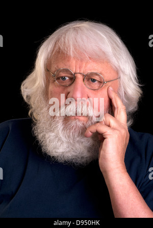 Vieil homme avec barbe complète et verres pensée avec sa main au menton Banque D'Images