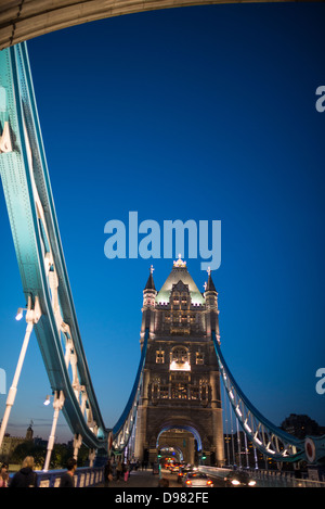 Tower Bridge au crépuscule Londres Angleterre // LONDRES, Royaume-Uni — L'emblématique Tower Bridge enjambe la Tamise dans le centre de Londres, illuminé à la tombée de la nuit. Achevé en 1894, ce pont suspendu et basculant combiné est l'un des monuments les plus reconnaissables de Londres, reliant la ville de Londres à Southwark sur la rive sud. Les tours néo-gothiques et les éléments de suspension bleus sont des caractéristiques distinctives de la structure de l'époque victorienne, qui ouvre environ 1 000 fois par an pour permettre le passage du trafic fluvial. Le pont est adjacent à la Tour de Londres, d'où il prend son nam Banque D'Images