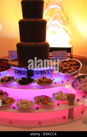 Fontaine de chocolat géante avec plein de bols de trempage Banque D'Images