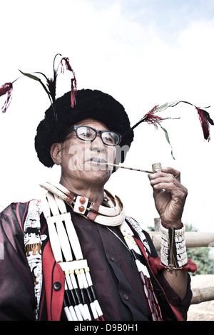 L'homme tribal Naga en tenue traditionnelle pipe, Hornbill Festival, Kohima, Nagaland, Inde Banque D'Images