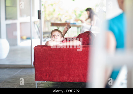 Boy lying on sofa Banque D'Images