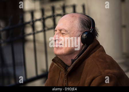 Senior man with eyes closed wearing headphones Banque D'Images