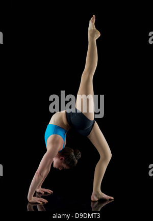 Acrobat performing in front of black background Banque D'Images