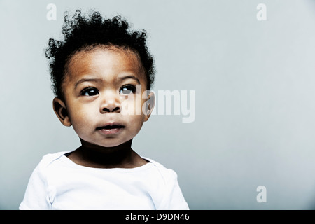 Portrait of baby boy wearing white vest Banque D'Images