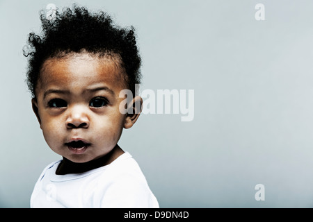 Portrait of baby boy wearing white looking at camera Banque D'Images