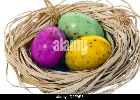 Trio d'oeufs de Pâques colorés dans un nid. Banque D'Images