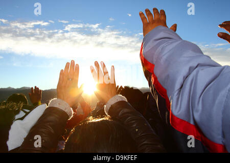 LA PAZ, BOLIVIE, 21 juin. Les Boliviens peuvent contenir jusqu'à leurs mains pour recevoir la chaleur et l'énergie du soleil levant lors d'un événement pour célébrer le Nouvel An Aymara ou Willka Kuti (aussi le solstice d'hiver). Lever du soleil marque le début de la nouvelle année (5521 dans le calendrier Aymara, Willka Kuti signifie littéralement retour du soleil). Credit : James Brunker / Alamy Live News Banque D'Images