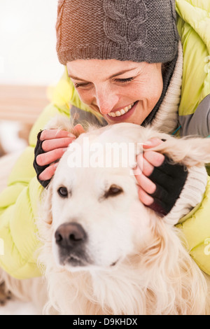 Woman in Knit hat stroking dog