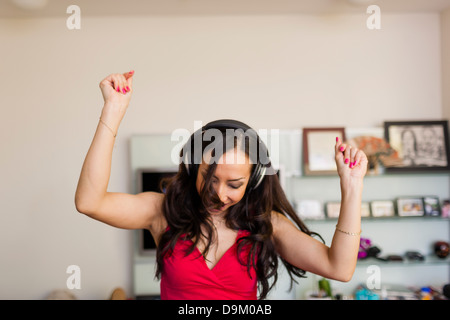 Mid adult woman wearing headphones et danse Banque D'Images