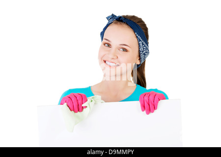 Smiling happy cleaning woman showing blank sign board. Banque D'Images