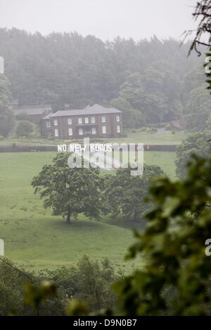 Cheshire, Royaume-Uni. 23 juin 2013. 20 militants vêtus de roadbuilders' high viz vêtements et casques de déployer une fausse route dans le champ juste au-dessous de Crag, Cheshire Hall dans les motifs qui le chancelier de l'echiquier George Osborne a une résidence . La protestation a été faite pour mettre en évidence la libération prévue de l'argent pour des programmes de construction de routes dans tout le Royaume-Uni dans les dépenses reivew imminente le mercredi 26 juin Crédit : Adrian arbib/Alamy Live News Banque D'Images