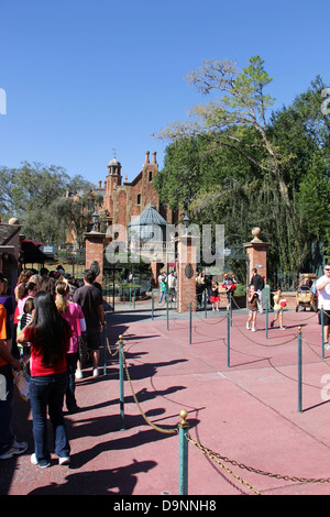 Disney World Magic Kingdom, personnes en ligne pour assister à la maison forêt hanté l'attraction. Banque D'Images