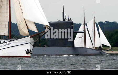 Sous-marin néerlandais Dolfijn passe entre navires à voile traditionnel hollandais volant et un autre navire à voile off Kiel-Schilksee, Allemagne, 24 juin 2013. Le sous-marin a été l'un des visiteurs militaires de la Semaine de Kiel. Photo : Carsten REHDER Banque D'Images