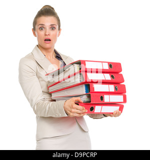 Surprised business woman holding pile de dossiers Banque D'Images