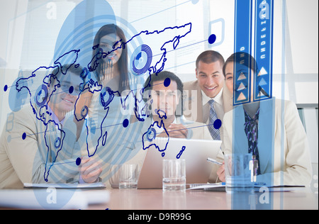 Smiling business workers looking at blue map interface Banque D'Images