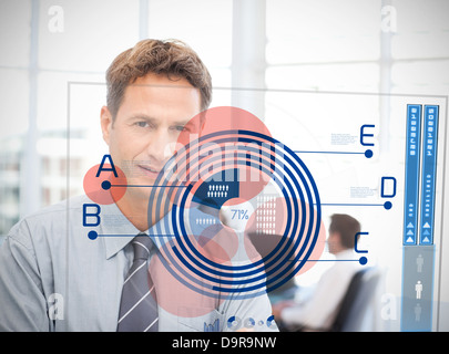 Businessman looking at blue diagram interface Banque D'Images