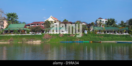 Vue panoramique horizontal (2 photo stitch) vue de la rivière hôtels et bars le long de la rivière Nam Song à Vang Vieng. Banque D'Images