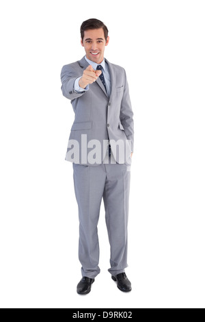 Smiling businessman pointing at the camera Banque D'Images