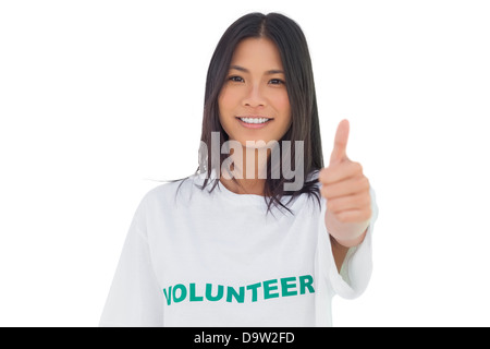 Jolie femme bénévole avec thumb up Banque D'Images