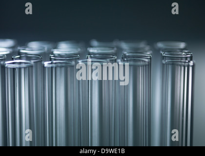 Un close-up de trois rangées de tubes verticaux sur un fond dégradé gris foncé Banque D'Images