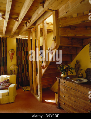 Commode ci-dessous escalier en bois dans le pays de séjour avec plafond en bois avec poutres apparentes Banque D'Images