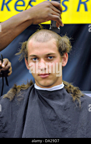 Les nouveaux étudiants de l'Académie navale américaine connue sous le nom de plèbe ont leur couper les cheveux au cours de l'induction Day le 27 juin 2013, à Annapolis, MD. Journée d'intégration commence lorsque la plèbe entrants sont émises des uniformes, étant donné les examens médicaux, l'enregistrement complet, recevoir des coupes de cheveux et apprenez à saluer. Banque D'Images