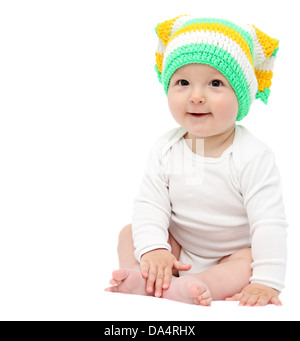 Beautiful happy baby boy sitting on white bed Banque D'Images